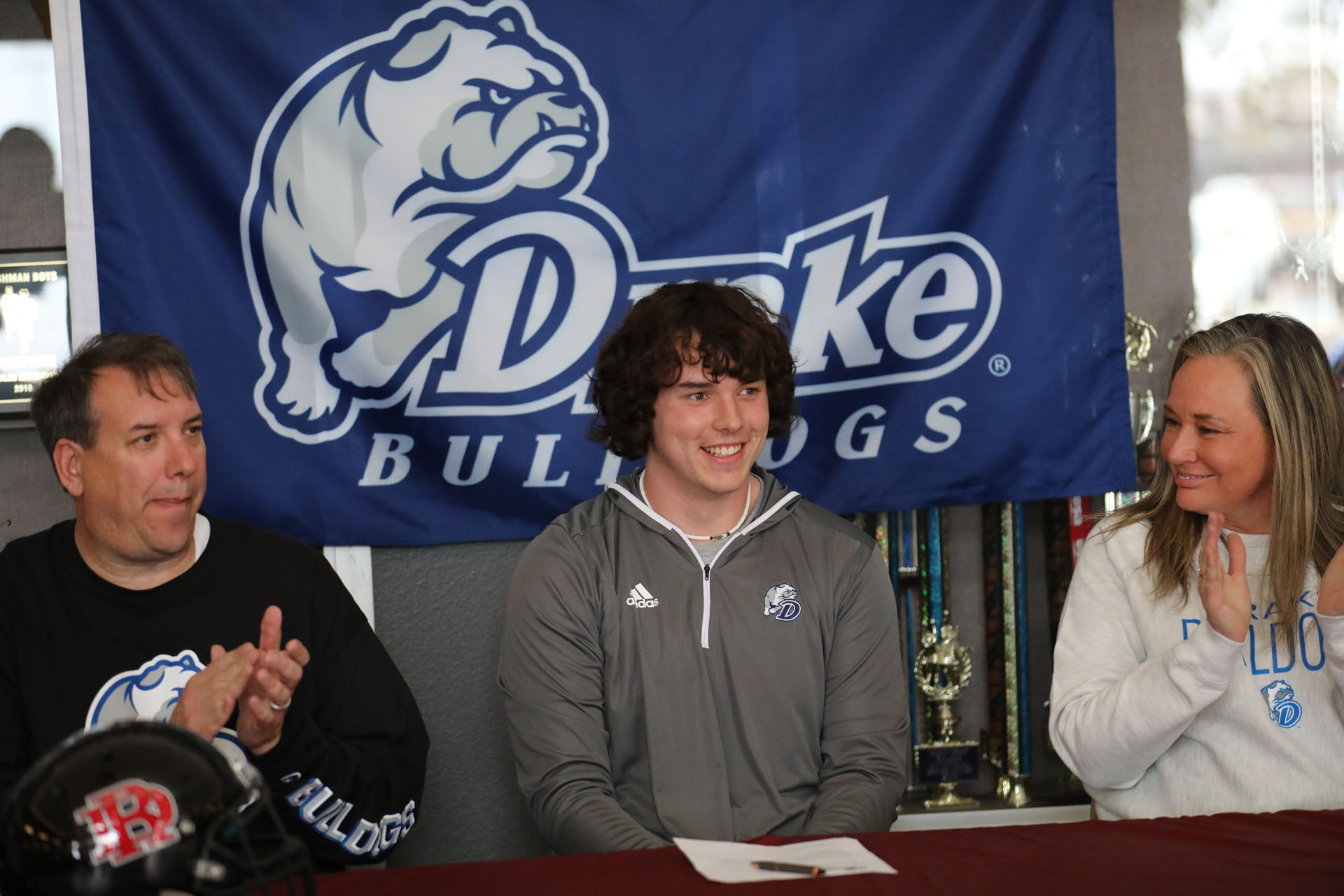 All smiles as he is about to sign to Drake